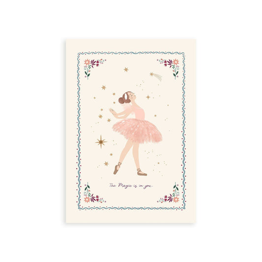 Picture of an art print showing a ballerina called Alicia in a graceful pose on an off white background surrounded by gold stars with the magic is in you written underneath her. surounded by a thin blue wavy border with red dots either side and flowers and foliage delicately sitting in each corner