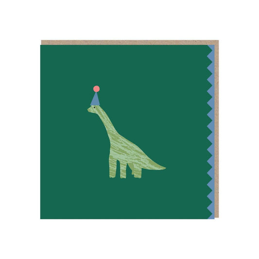 Square deep green card with a light green diplodocus in the middle wearing a blue party hat with a pink pom pom. The right edge has a blue zigzag pattern. Comes with a brown kraft envelope