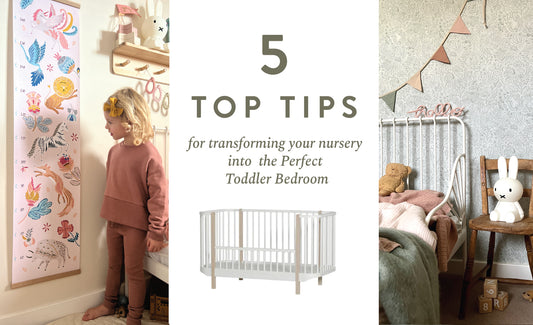 Photo showing a toddler looking at a height chart on the left, 5 tips for transforming your nursery into the perfect toddler bedroom with an oliver furniture cot and a toddler bedroom with garden doodles wallpaper