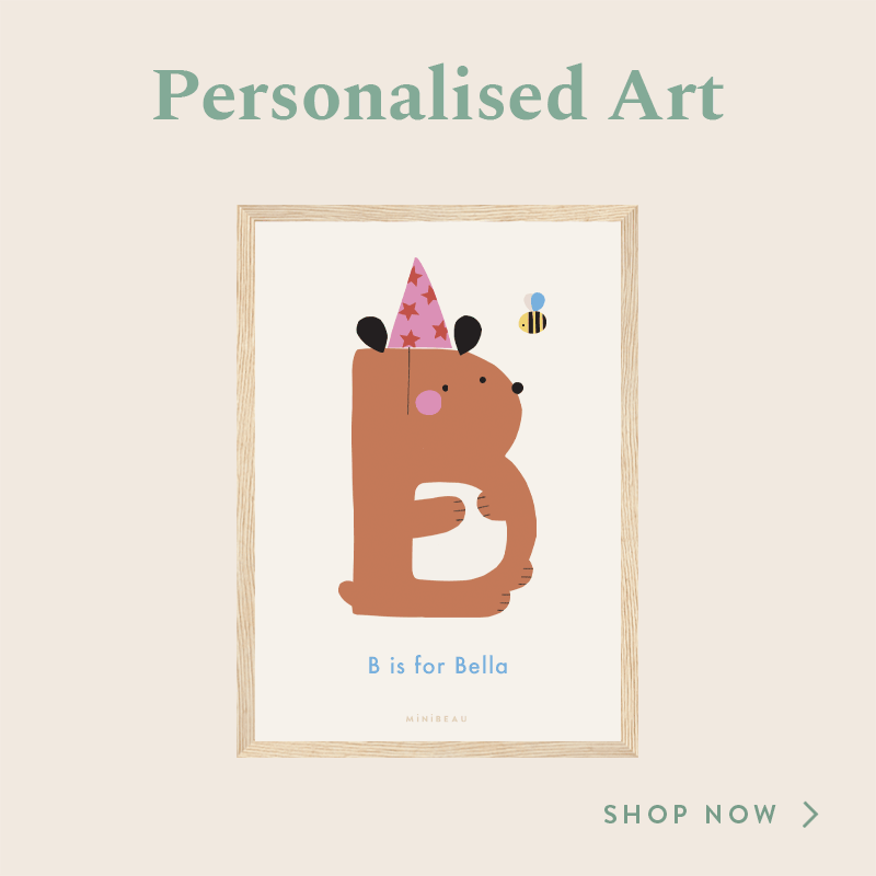 PERSONALISED B IS FOR ART PRINT SHOWING A BEAR IN THE SHAPE OF A B WEARING A PINK PARTY HAT WITH STARS ON, WITH A BEE BUZZING ROUND IT'S HEAD. THE WORDS B IS FOR ARE AT THE BOTTOM AND THE NAME CHANGES FROM BELLA TO BENJAMIN AND BACK AGAIN.