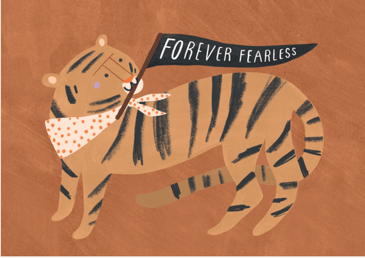 "Forever Fearless" Tiger Greeting Card – A warm-toned greeting card featuring an illustrated tiger in shades of orange and brown, walking confidently while holding a black flag in its mouth that reads “Forever Fearless” in white letters. The tiger wears a light beige bandana with orange polka dots, and the background is textured ochre/deep orange.