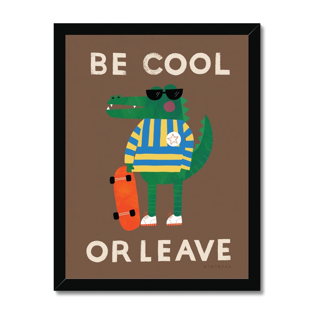 Art print in a black frame. Our be cool or leave art print show a crocodile in a yellow and blue striped jumper and sunglasses, standing on his hind legs holding a skateboard, with the words be cool or leave in an off-white on a brown background.