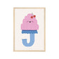 Art print in a light wood frame. Our Happy Alphabet 'J' Art Print shows a smiling pink moulded jelly on a blue stand in the shape of a J, with cherries on top of the Jelly on a neutral background.