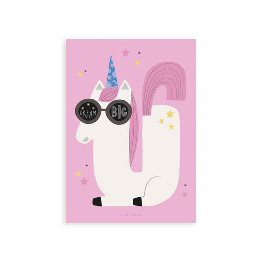 Our Happy Alphabet 'U' Art Print shows a cool, sunglasses-wearing white unicorn, laying in the shape of a U with a pink tail and blue horn with yellow stars on its back. The words DREAM BIG are in the lenses of the sunglasses. All on a pink background.