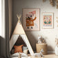 The corner of a childs playroom with a neutral teepee, leopard print side table, and grey dotted and striped pouffe, the wall wallpapered in a neutral colour with black dots spaced out across the wall irregularly. Toys are in the foreground. On the wall art 2 art prints in light wood frames. The larger being our love our planet koala art print and the smaller being our mercado de flores art print. 