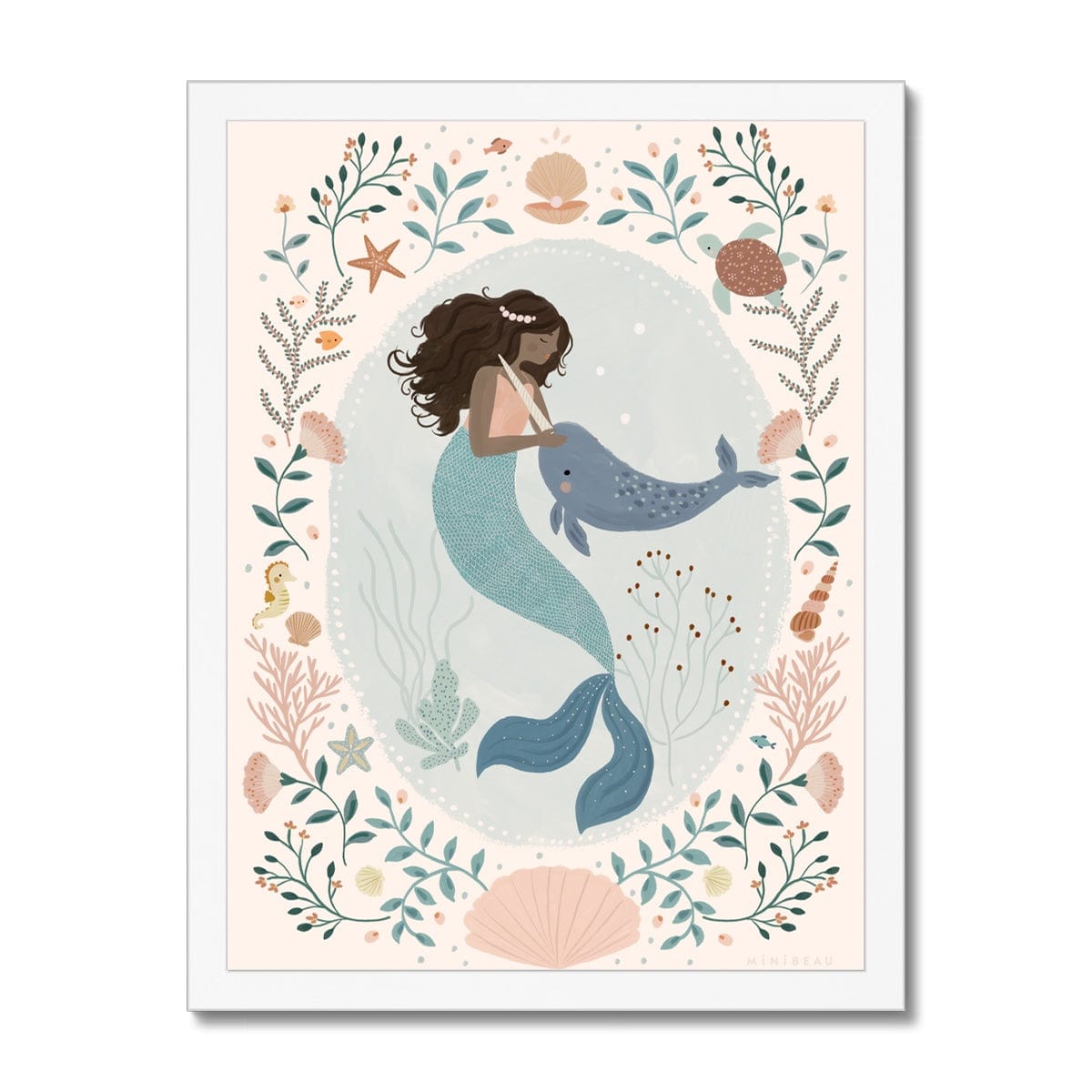 Beautiful dark skinned and haired mermaid with a pearl headband petting her friend Narwhal within a pale teal coloured oval background with white dots round the edge. On the outside of the oval is a sea themed border on a neutral background. The border consists of foliage, flowers and items you would find at the bottom of the sea, shells, turtle, sea horse with a large clam shell at the bottom, in a white frame
