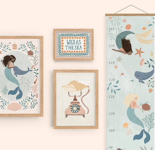 Showing a gallery wall of our Sea Foliage mermaid, ocean calling and wild as the sea art prints in natural wood frames on a neutral background, with our mermaid height chart with oak hanger