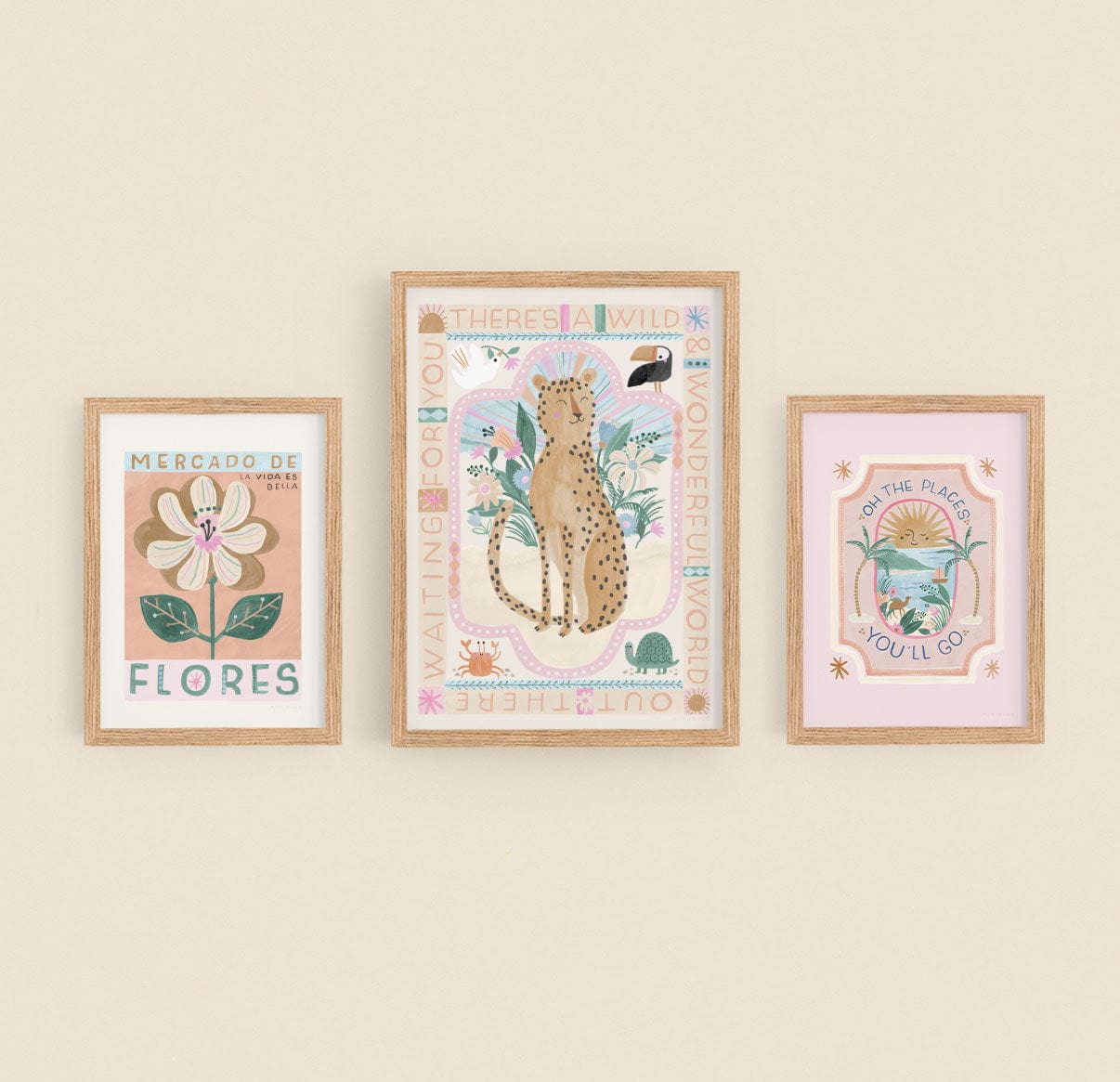 Showing a gallery wall of our wild, wonderful world, mercado de flores, and oh, the places you'll go prints in natural wood frames on a neutral painted wall