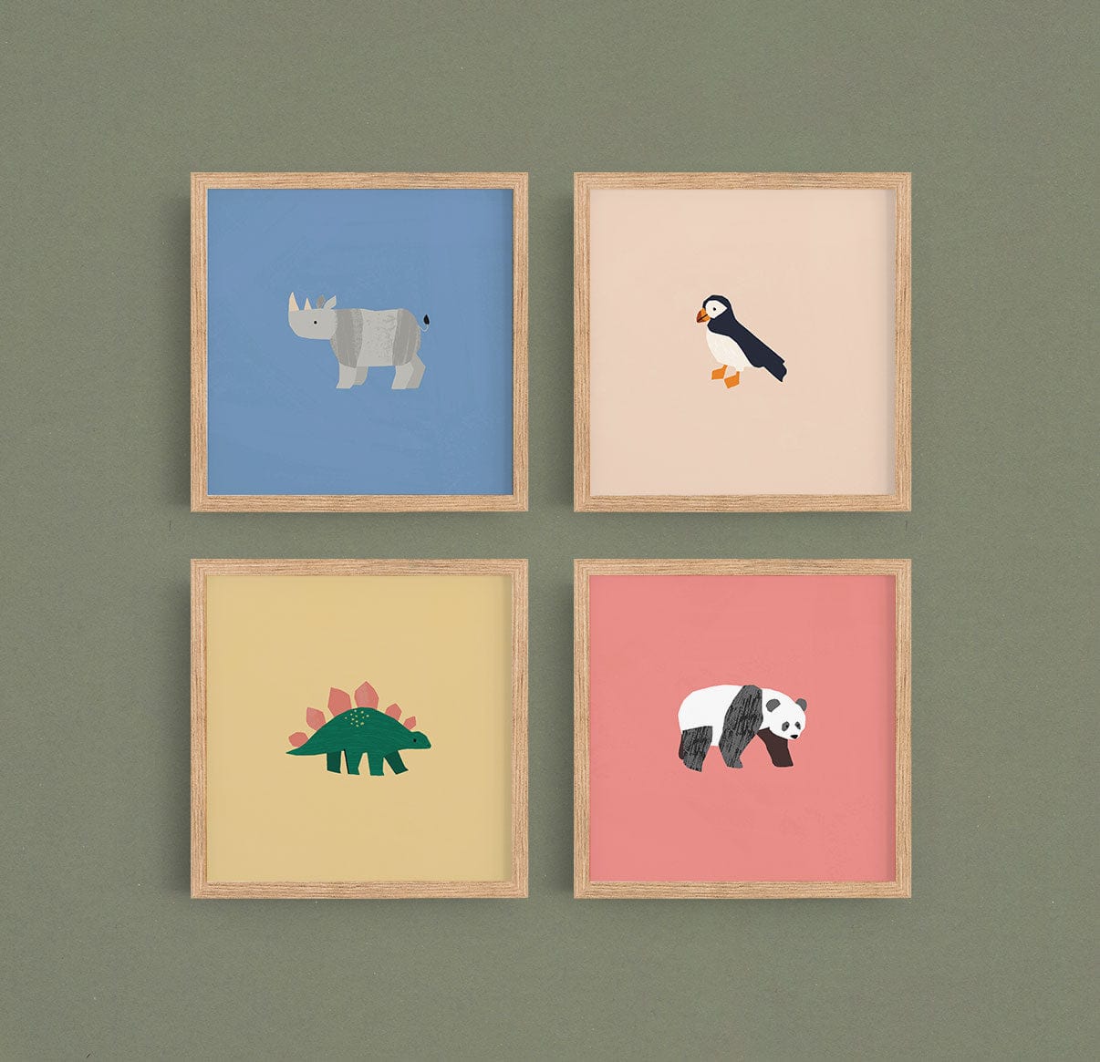 Image of a gallery wall made up of our square safari art prints, puffin, rhino, dino, and panda in natural wood frames on a green background