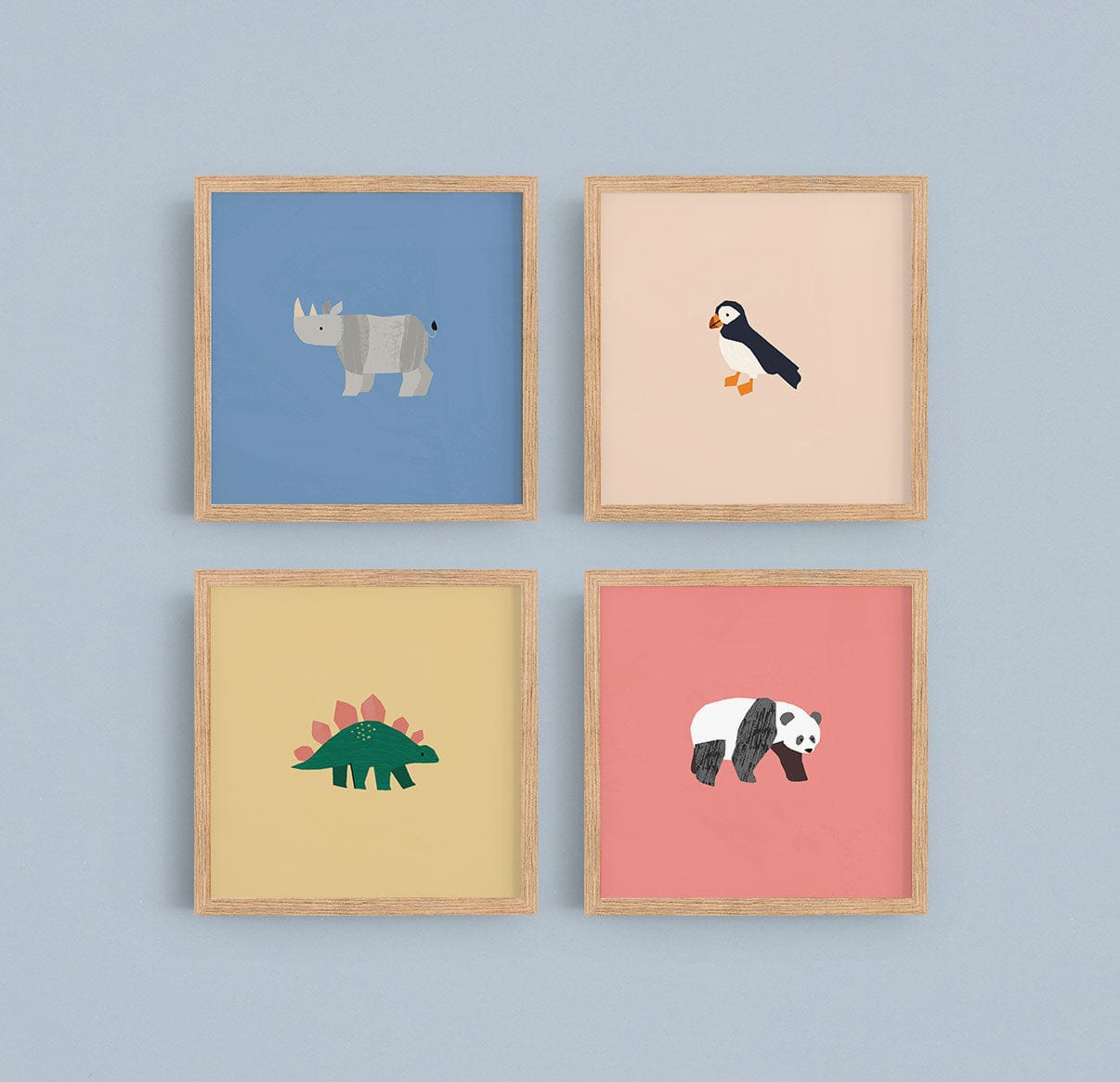 Image of a gallery wall made up of our square safari art prints, puffin, rhino, dino, and panda in natural wood frames on a sky blue wall