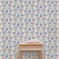 Wallpaper blue flowers, pink leaves and green leaves with bench and cosy blankets